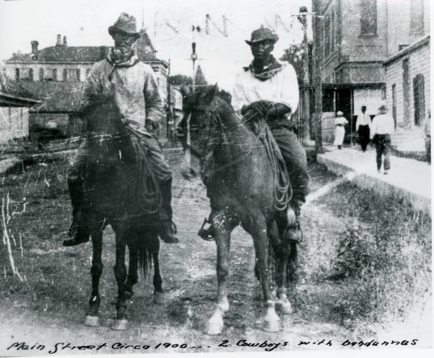 African American cowboys riding down Main Street in the early 1900s. Image is courtesy of Victoria Regional History Center.
